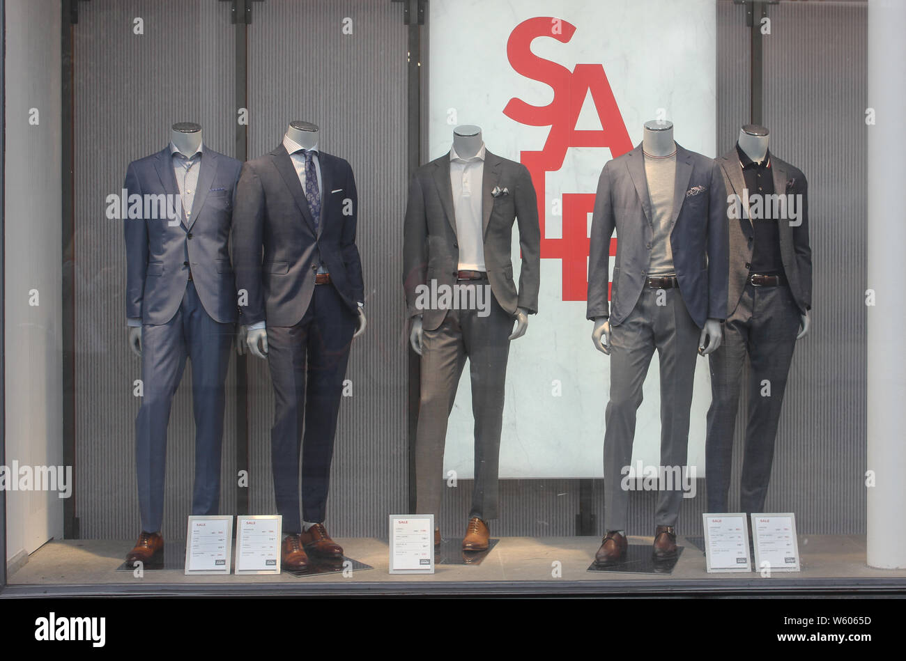 Men`s clothing sales in shopping area Munich, display decoration with sale signs. Stock Photo
